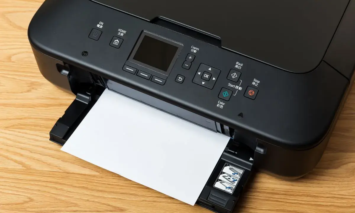 Imprimante noire avec une feuille de papier, prête à imprimer. Le câble USB est connecté, permettant la transmission des données.