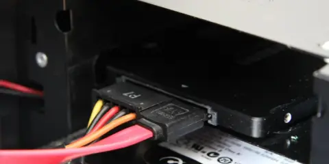 Connexion des câbles SATA pour installer un SSD dans un boîtier d'ordinateur.