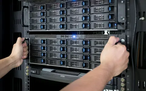 Mains d'un technicien installant des disques dans un nas server.