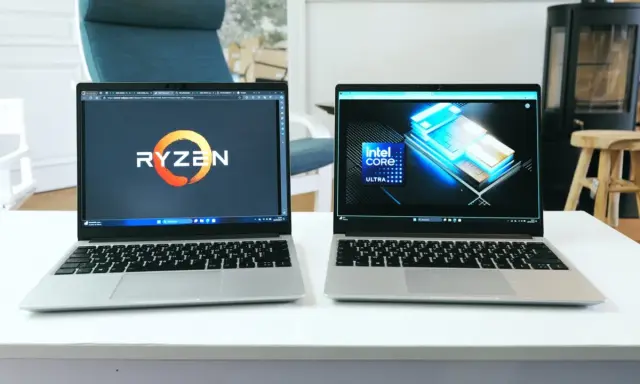 Deux ordinateurs portables côte à côte, l'un affichant le logo Ryzen, l'autre le logo Intel Core Ultra. Un **framework computer** pour chaque processeur.